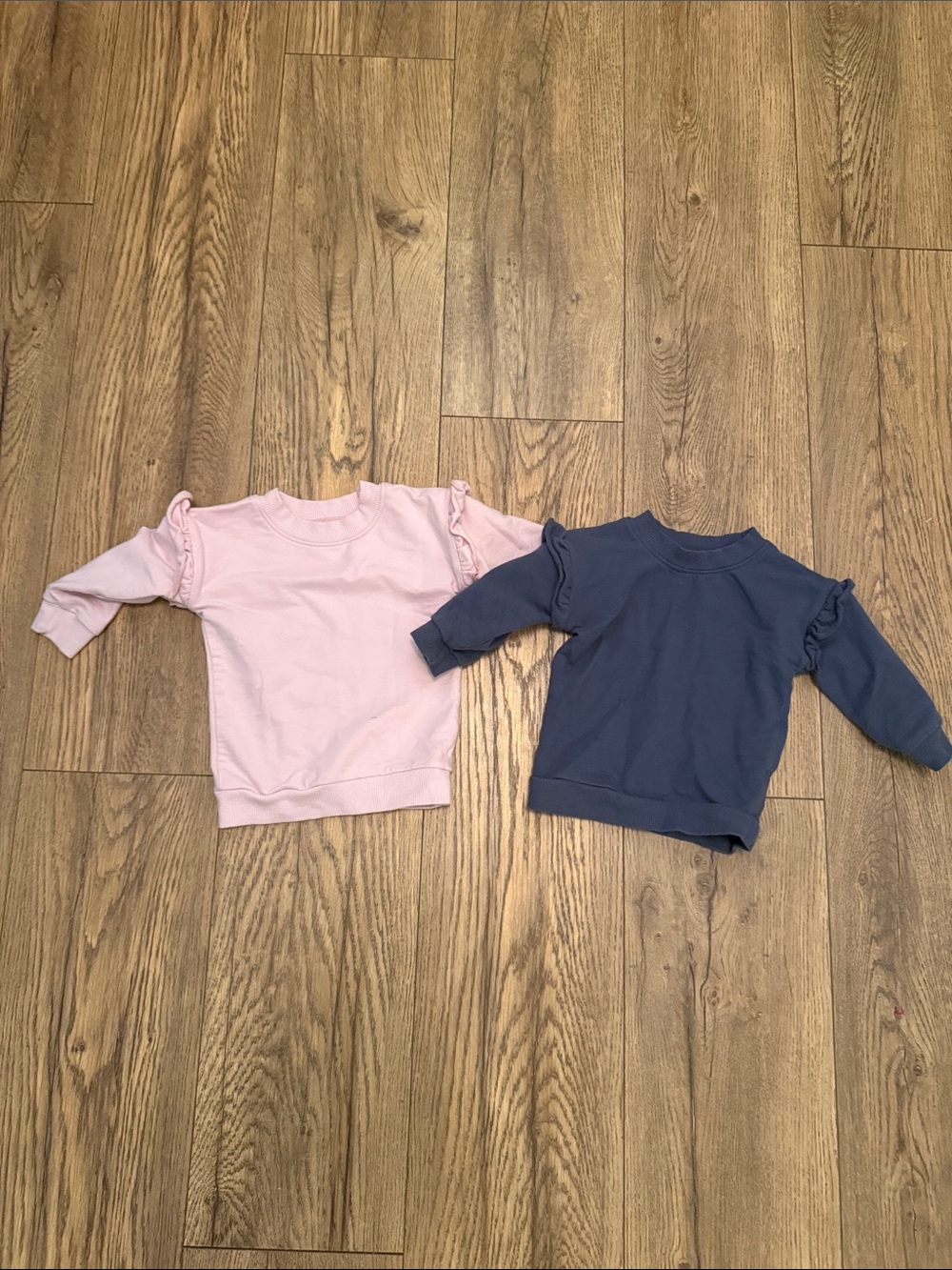 Two ruffle sweat shirts